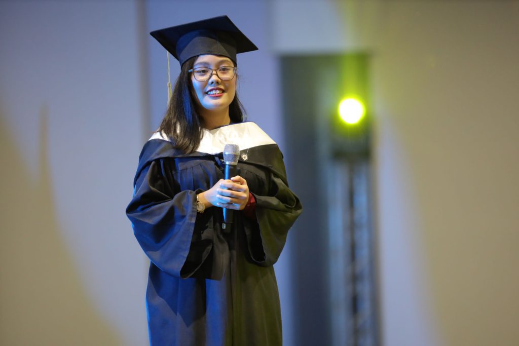Summa cum laude graduate Tricia Corraine Tagle delivers her speech during the college commencement exercises.