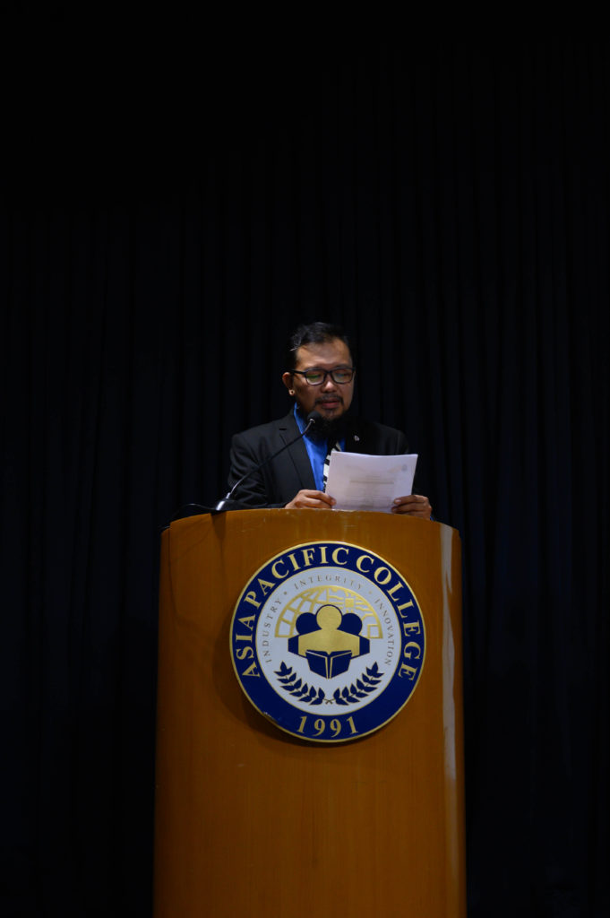 ABM and HUMMS Strand Head Gino Caliwagan announces the names of the academic excellence awardees. Photo by Terrence Luigi Matel